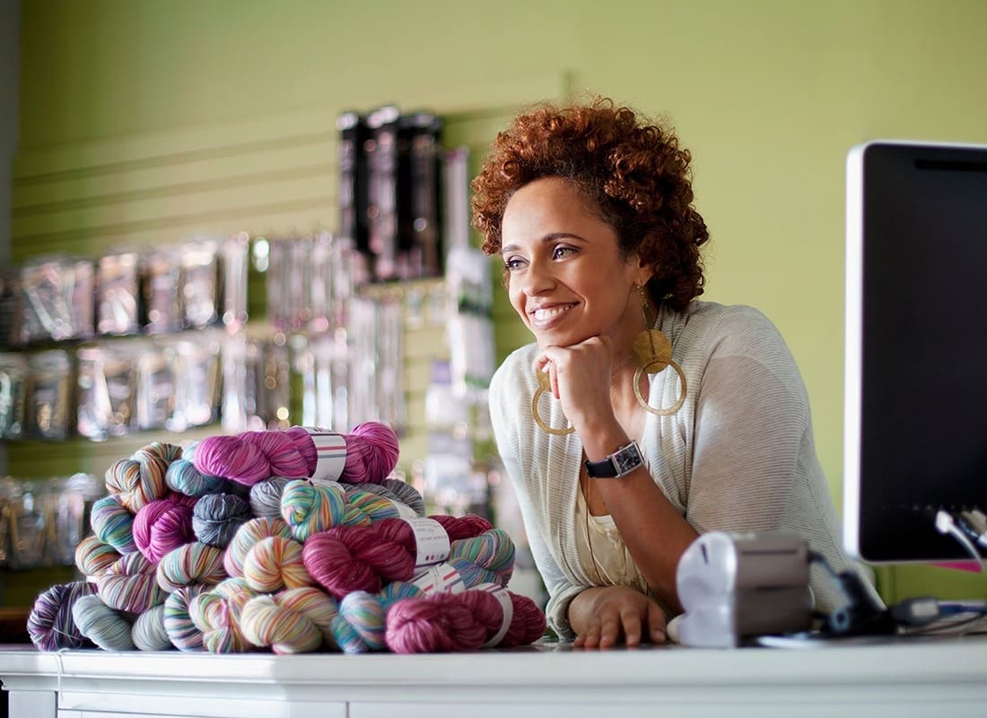 Investment Services - Yarn Shop Owner Happily Waits For Customers